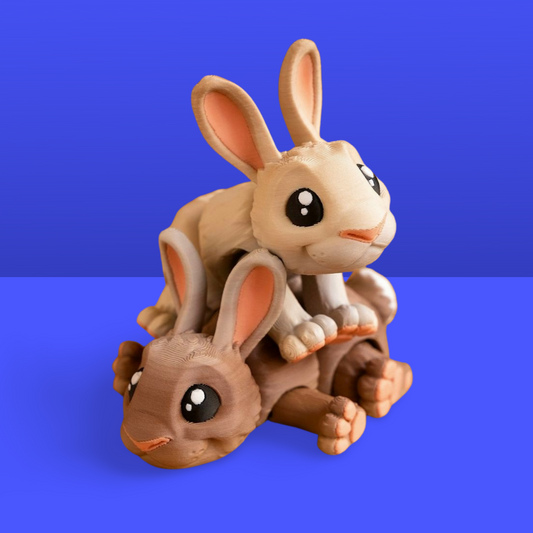 Two 3d printed bunny rabbit miniatures on a blue background